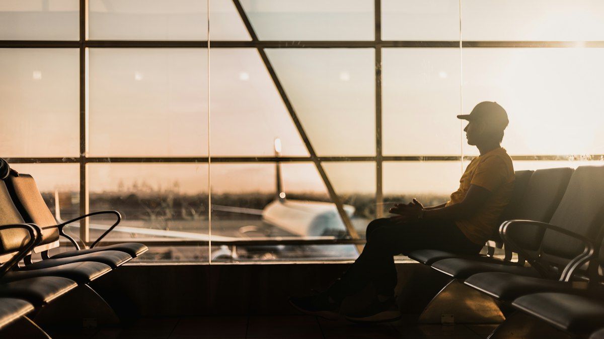 Traveller waiting by an airport window